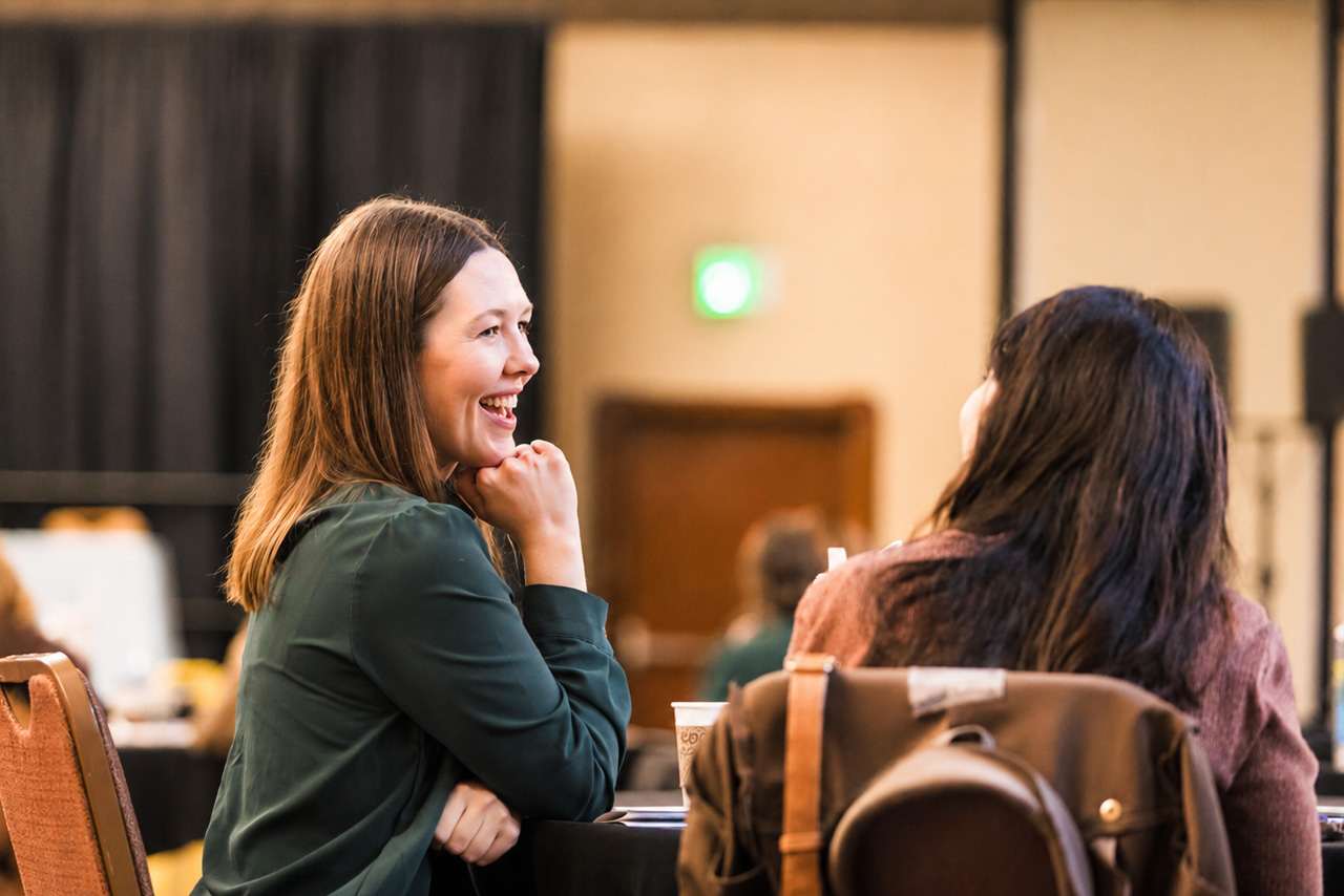 Two colleagues chat at the Missouri Oral Health Policy Conference.