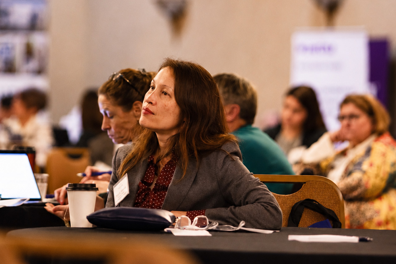 Woman listens to a presentation on how to provide better resources for dental Medicaid providers.