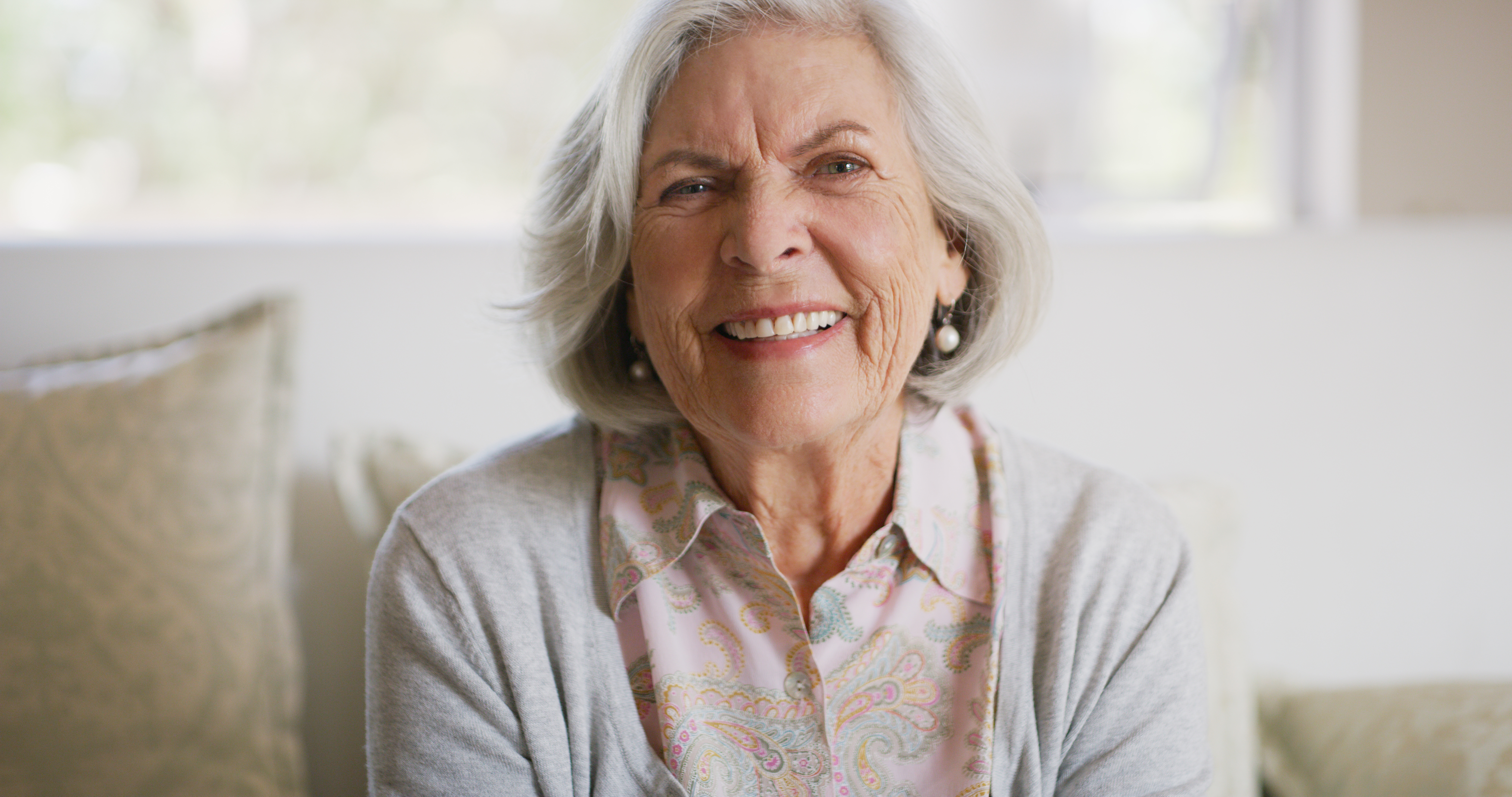Smiling older woman at home representing healthy aging and Missouri oral health awareness.